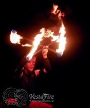 Fire performer with double staff in Victoria