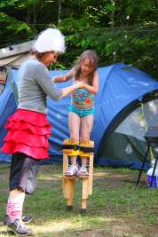 Circus perfomer teaches child stilting in Victoria